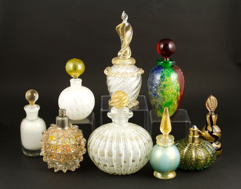 9 Muranese Vanity Accessories: Group of nine Muranese dresser/vanity accessories, to include: two atomizers and seven perfumes, one labeled indistinctly, one signed indistinctly, 8"h (tallest). Provenance: Collection of Robert Loy.