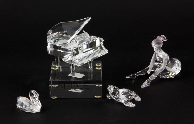 Lot of Five Swarovski Crystal Miniatures: Lot of five Swarovski crystal miniatures, to include: one grand piano, one figure of a girl, one swan, and one seal, and one piano bench, largest 3" long. Provenance: From a La Jolla, CA estate.