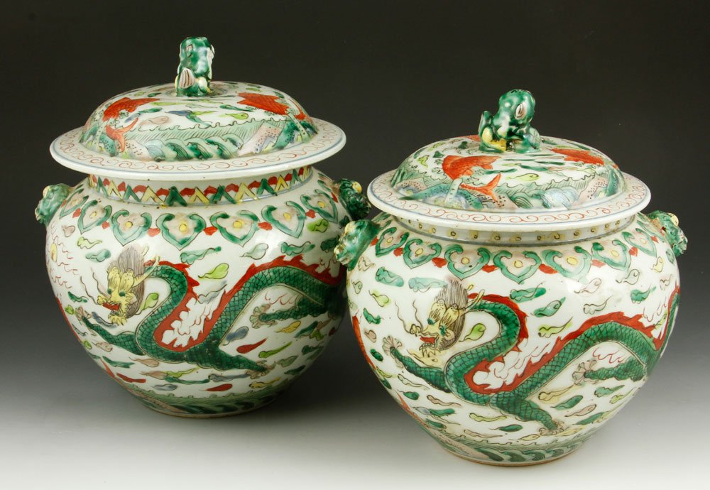 Chinese Ginger Jars: Two almost identical covered ginger jars, China, decorated with dragons, fishes and foo dogs, 9" h x 8 1/2".