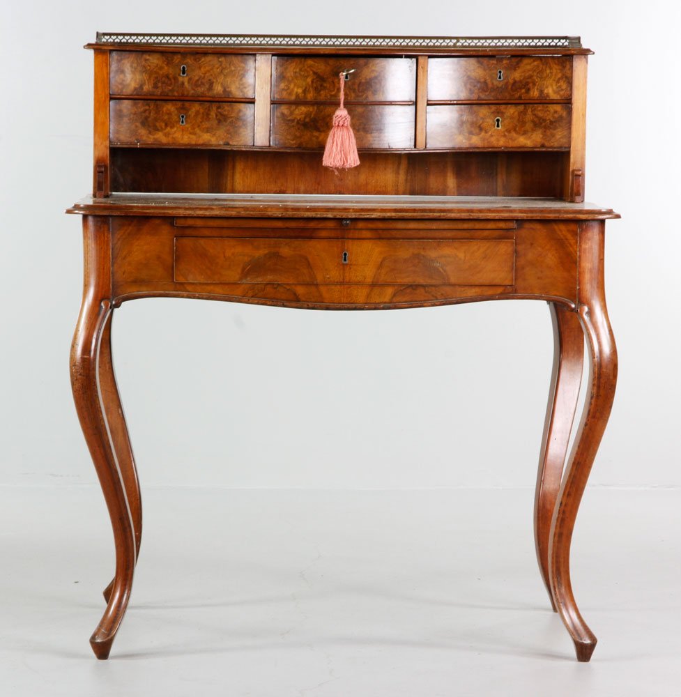 19th C. French Ladies Desk: 19th Century French ladies' desk with burl finish, cabriole legs, brass gallery top with key, six drawers, 42'' h x 37'' w x 24'' d. Provenance: Estate of Alexander Brook.
