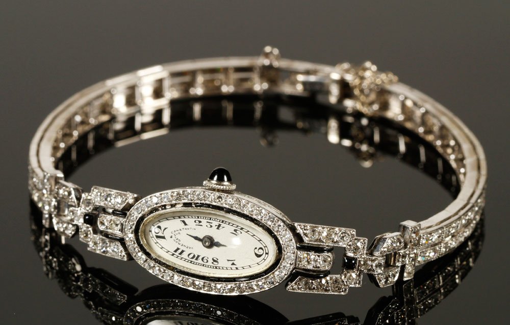 14K and Platinum Vacheron and Constantin Ladies' Watch: 14K gold and platinum Vacheron and Constantin ladies' watch, face framed with pieces of black onyx, onyx crown, V+C movement, band 14K with platinum case, approximately .75 oz/ 14 DWT TW excluding mov