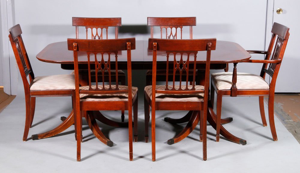 Mahogany Dining Table and 6 Chairs: Custom dining table, mahogany, includes six chairs (one arm, five side), 30"h x 37"w x 64"L (table), 36 1/2"h x 20"d x 20"w (chairs). Provenance: From a Beverly, MA collection.