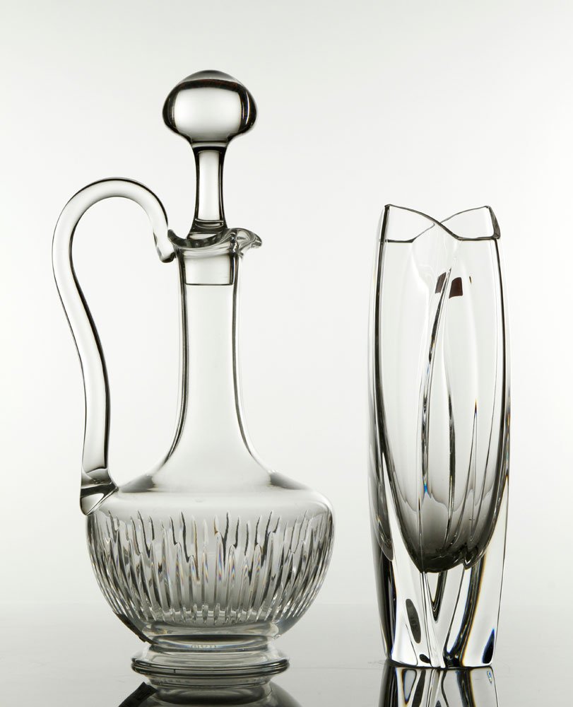 Baccarat Cut-Crystal Decanter and Bud Vase: Baccarat cut-crystal decanter with stopper and handle of baluster form, and Baccarat glass bud vase, designed by Robert Rigot, etched "Baccarat, R. Rigot" on side, near base, both with etched Baccarat