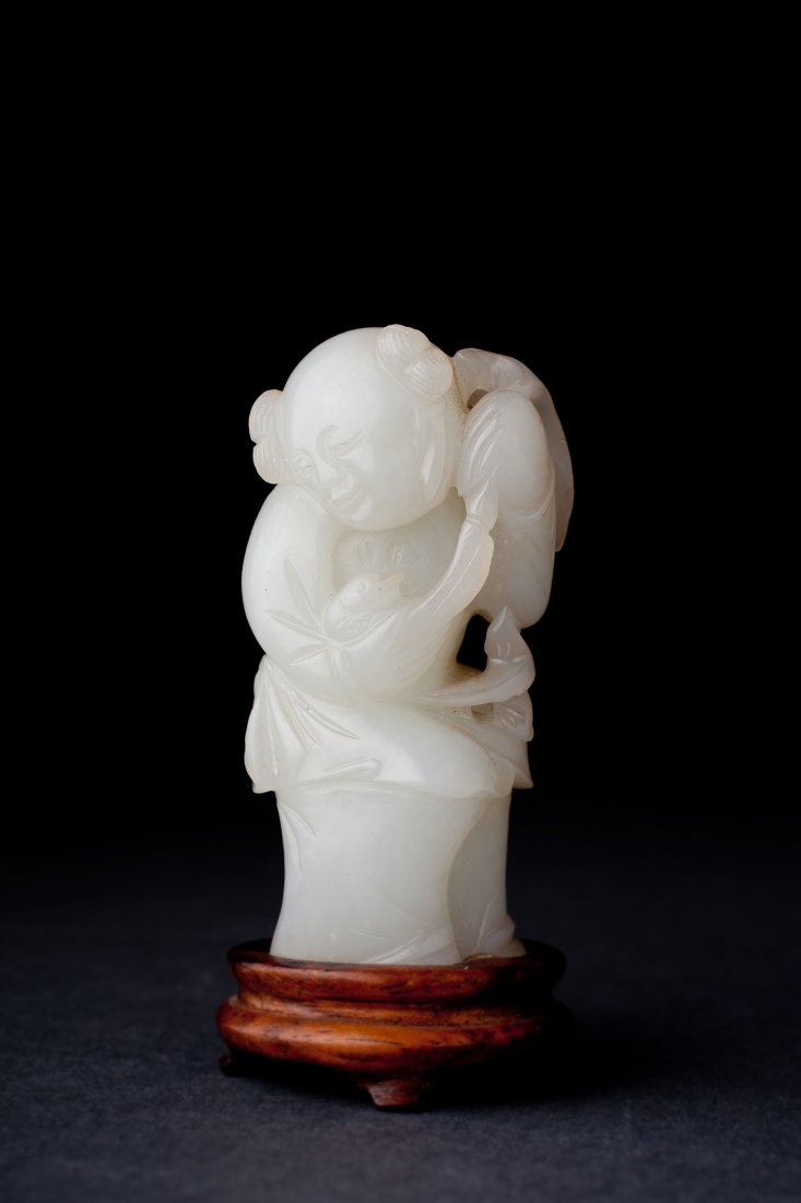 Antique Chinese White Jade Figure. Qianlong (1735-1795): Mutton fat white jade figure, Qianlong (1735-1795). Carved as a figure holding a duck and a sprig of fruit across back, 2 5/8" (3 1/4" on stand). Provenance: -From a private collection -Previously Gab