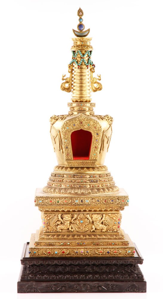 Chinese Gilt and Bronze Buddhist Stupa: Gilt and bronze model of a Buddhist stupa, China, 18th century, the stepped plinth supporting the domed mid-section with a niche surrounded by a flaming nimbus, below a rising spire of stylised paraso