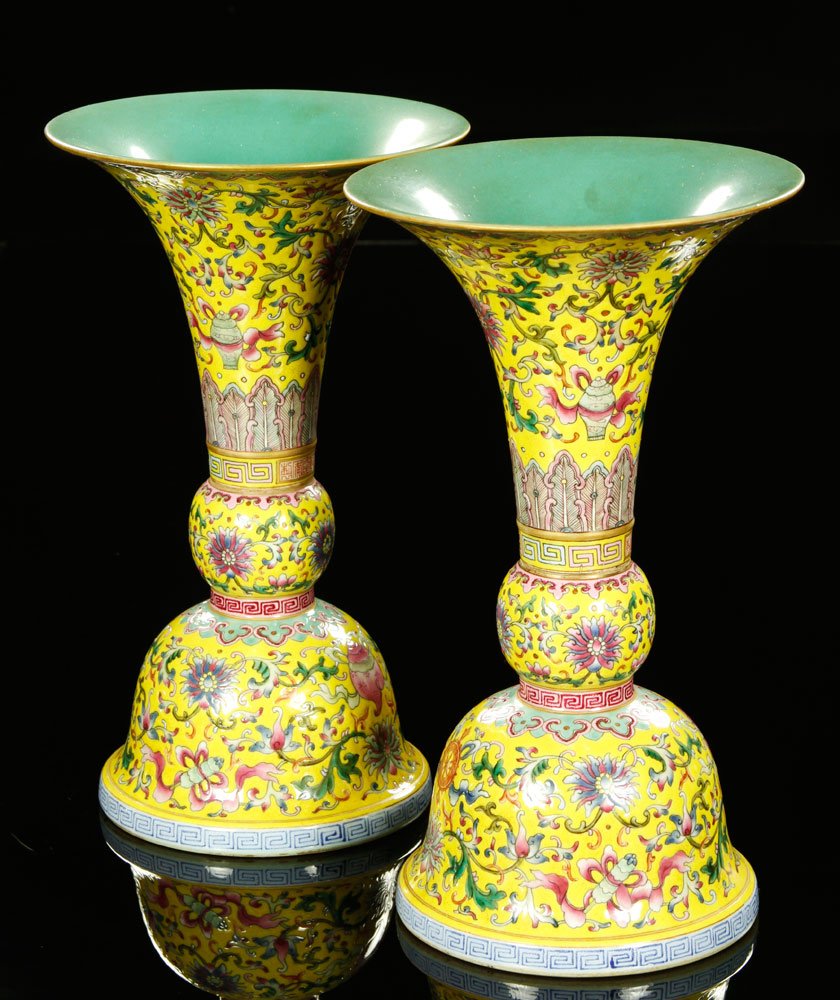 Chinese Pair of Famille Rose Gu Vases: Pair of yellow and famille rose glazed gu vases, China, decorated with the eight Buddhist treasures, Qianlong mark on base, 10 1/2" h.