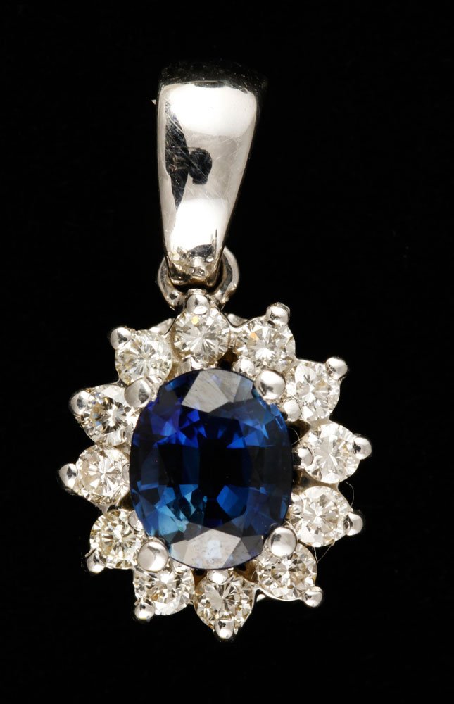 18K Diamond and Sapphire Pendant: 18k white gold, diamond and sapphire pendant, with 12 total diamonds, approximately .4 ctw, 1.10 ct sapphire, approximately .1 oz/ 2 DWT TW, 7/16" h. Provenance: From a Haverhill, MA estate.