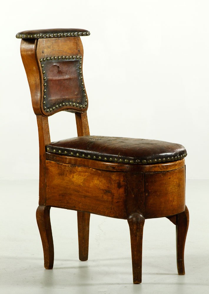 18th C. French Provincial Leather Commode: 18th century French provincial leather potty chair/commode with brass tacks and brown leather, with lid that lifts to reveal porcelain floral basin, 30 1/2" h x 11" w x 17 1/2" d. Provenance: From a N