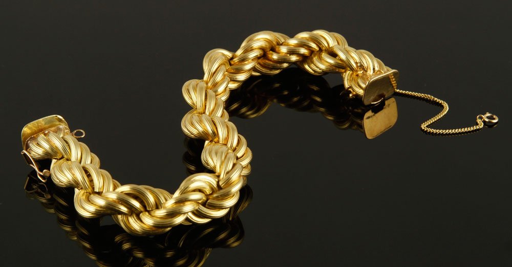 18K Twist Bracelet: 18k gold rope twist bracelet, with safety clasp and chain, 8 1/4" l, approximately 1.8 oz/ 32 DWT TW. Provenance: From a Concord, MA estate.