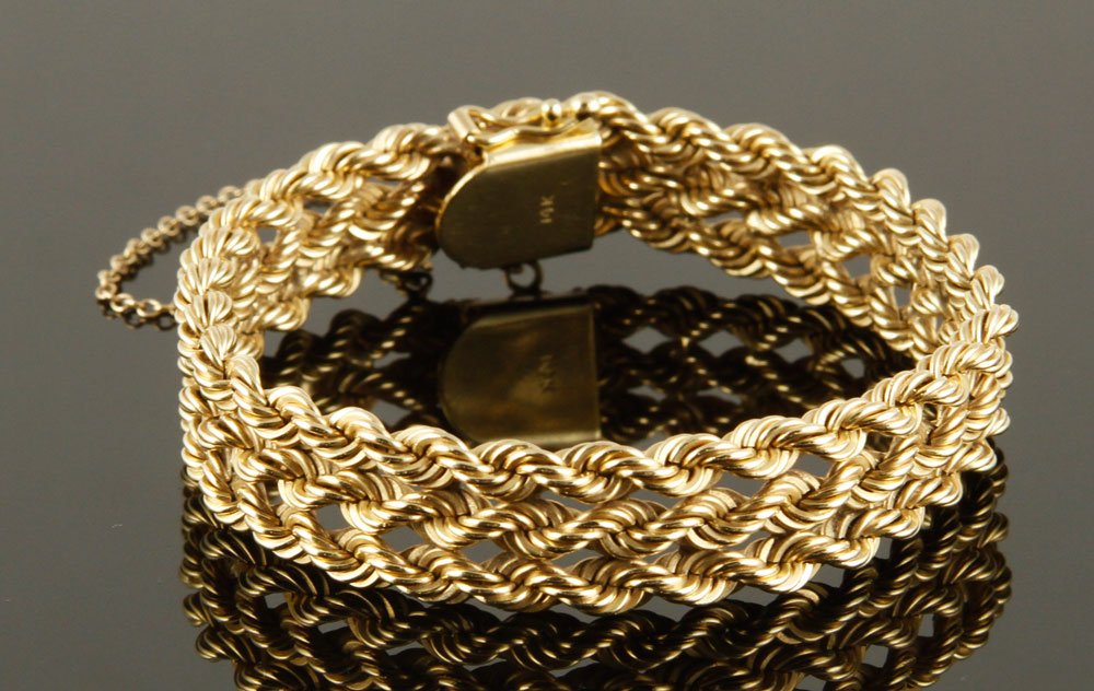 14K Woven Link Bracelet: 14k gold woven link bracelet with safety clasp and chain, approximately 7" l, approximately 1.4 oz/ 28 DWT TW. `
