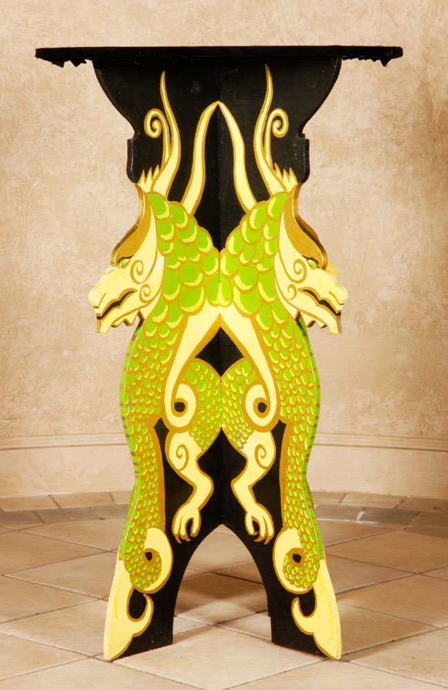 Dragon Illusion Magic Table: Dragon illusion table, hand painted wood with green and yellow dragons on black background, similar construction to Le Grand David's Zombie table, 43"h x 26 1/4"dia. Provenance: From Marco the Magi's