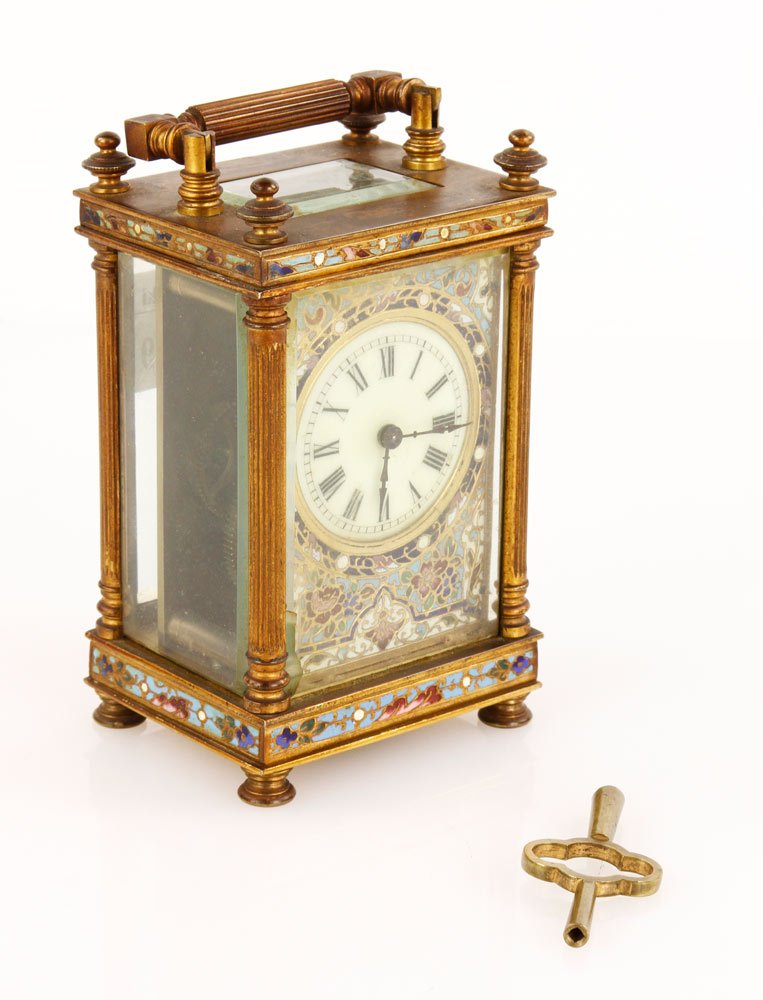 French Champlevé and Brass Carriage Clock: French Champlevé and brass carriage clock, enameled dial, floral decoration, black spade hands, 6" x 3" x 2 1/4". Provenance: CA estate.