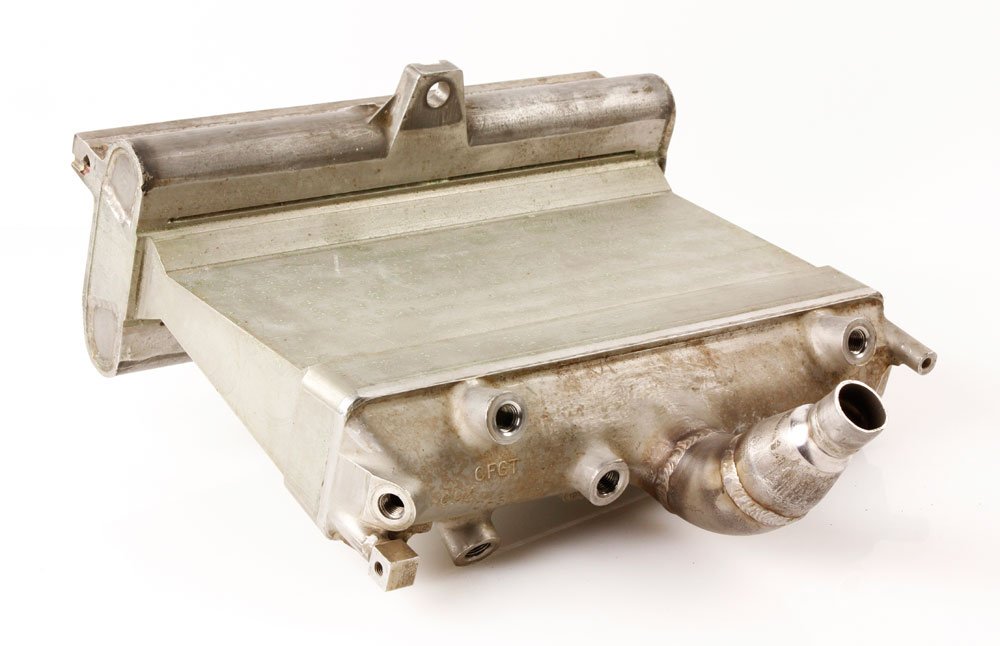 Apollo Program Rocket Engine and Lunar Landing Photo: Apollo Program rocket engine, Lenier engine segment, stainless steel, circa 1960, along with photograph of an astronaut on the surface of the moon, engine segment 15" h x 12 1/2" l x 6 1/2" d.