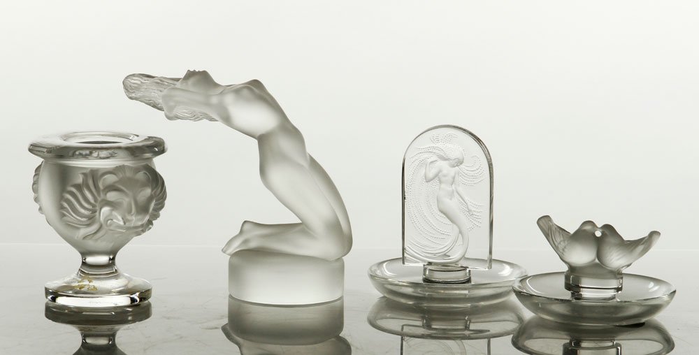 Lot of 4 Lalique Figures: Lot of four Lalique figures, including Lion lighter, Two Finches pin tray, Nymph pin tray, The Dancer glass sculpture, tallest 5 1/2" h. Provenance: From a Florida estate.