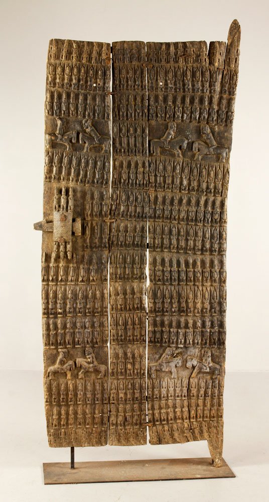 Important Carved Door, Dogon Tribe: Important carved door, wood and wrought iron, depicting warriors in battle, carved by an unknown male Dogon artist, Mali, West Africa, with original lock, intended to safeguard the Dogon tribe against
