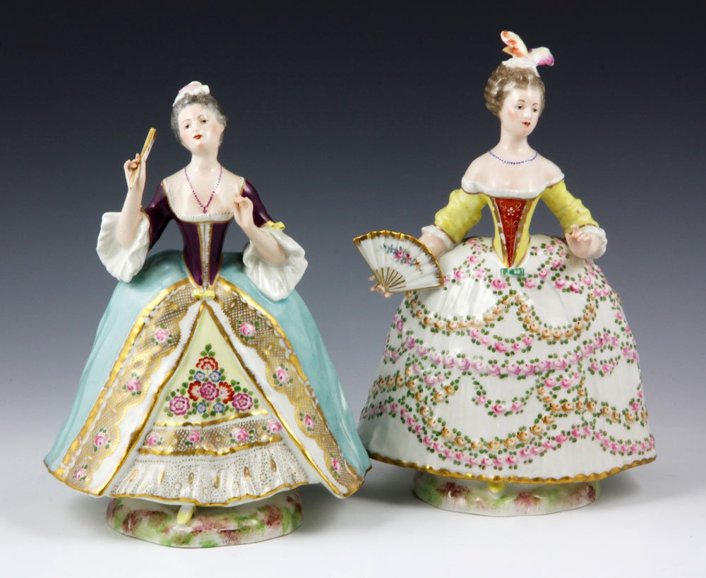 Lot of 2 18th C. French Porcelain Figures: Lot of two 18th century French porcelain figures of ladies, in ornate 18th century gowns, each holding a fan, with blue crossed arrow marks, 8 3/4" h x 9 3/4" w. Provenance: From a Murrieta, CA estate