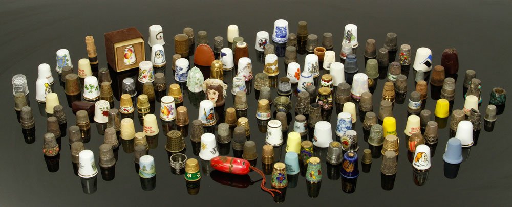 Large Antique Thimble Collection: Large antique thimble collection, including sterling, enameled, gold and other materials, approximately 150 pieces. Provenance: From a Framingham, MA estate.