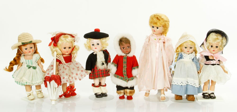 Lot of 7 Dolls: Lot of six Vogue Ginny dolls, to include: doll with white embroidery dress, Scotch, Lucy, Dutch girl, Jill with pink night dress, along with one Madame Alexander doll, and an Eskimo doll. Provenance: 