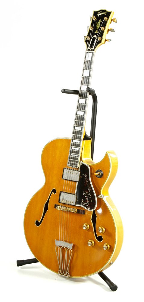 1960 Gibson Guitar: Gibson hollow bodied electric guitar, c. 1960, with original "Gibson Byrdland, Number A34663, guaranteed Gibson Inc." label intact inside body, neck inlaid with mother of pearl, in original hard-shell