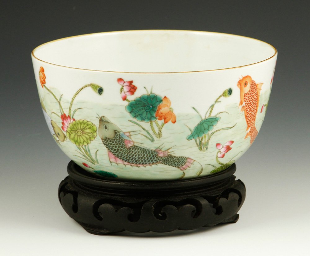 Republic Period Famille Rose Porcelain Bowl: Famille rose porcelain bowl, China, Republic Period, decorated with fish and lotus flowers, Dao Guang mark on base, with carved hard wood stand, 6 1/2"dia. Provenance: From an important Pennsylvania c