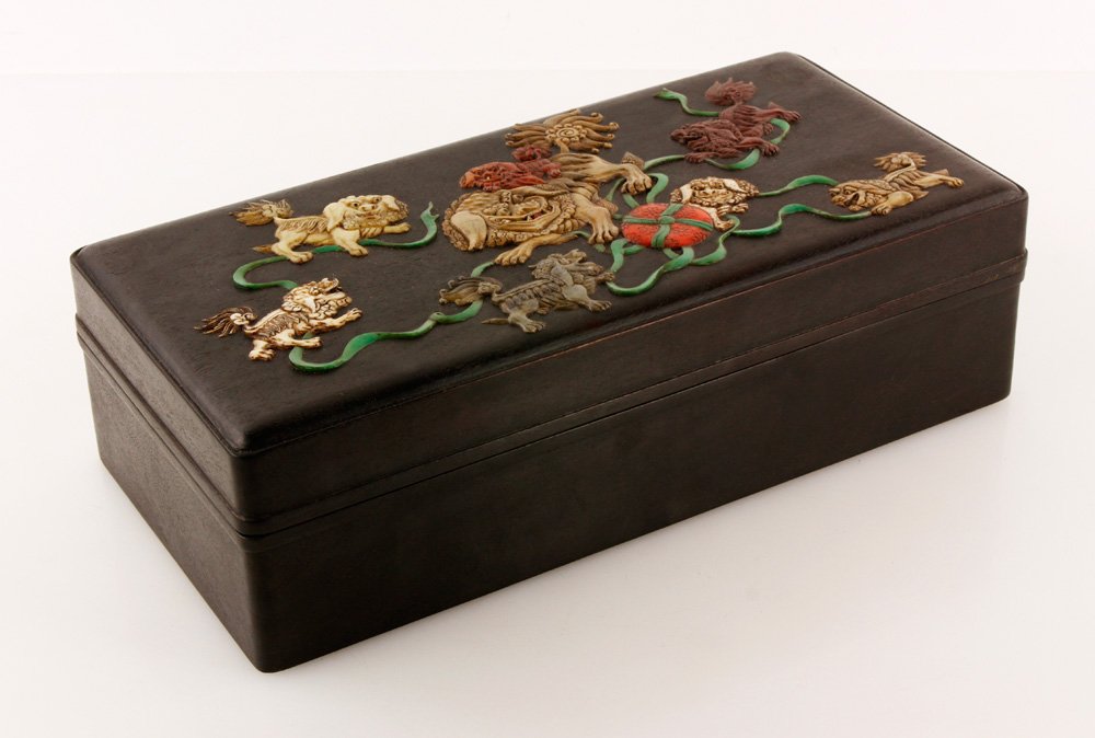 Chinese Zitan Box: Zitan box, China, cover mounted with soapstone dogs playing with ribbons, 3 1/2" l x 12 1/2" w x 6" d.