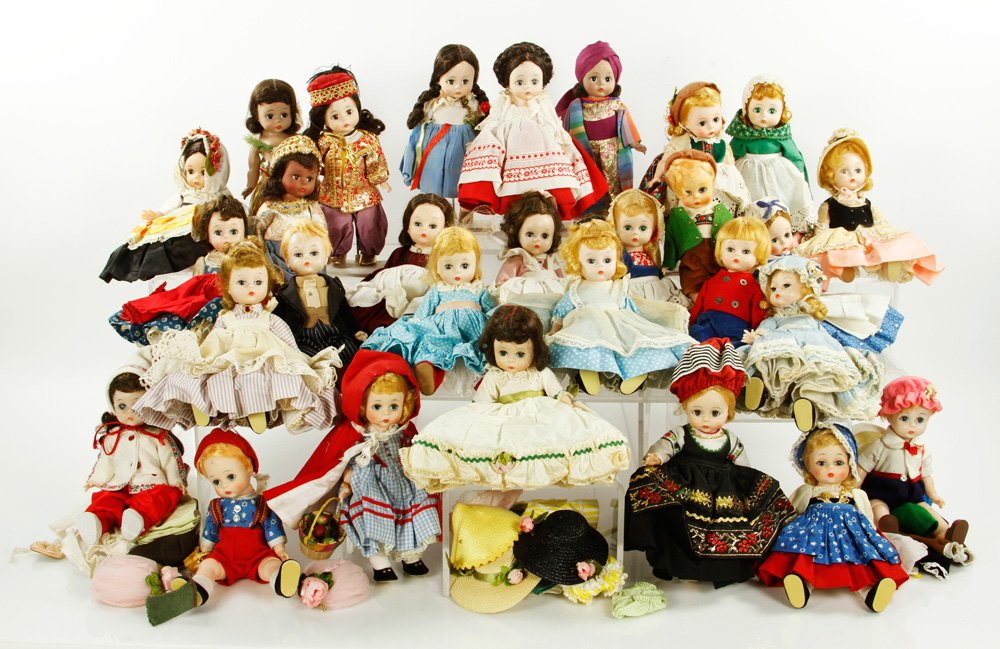 Lot of 30 Madame Alexander Dolls: Lot of thirty Madame Alexander dolls including Little Women and Dolls of All Nations, with original tags and stands, also includes additional clothes, trunk and storybook, 7" h (doll). Provenance: MA