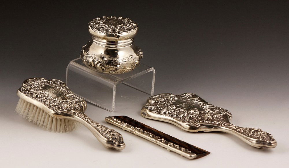 Art Nouveau Sterling Silver Dresser Set: Four piece Art Nouveau dresser set, sterling silver, to include mirror, brush, comb and jar, all pieces monogrammed and engraved "1899," mirror is 10 1/4"l. Provenance: From a California estate.