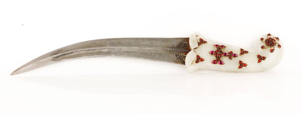 Dagger with Carved Jade Handle: Dagger with large carved jade handle, Pakistani or Afghani, applied red and pink glass beads with gilt surrounds inset into handle, base of blade etched with Islamic script and stars, 16"l. Provenance