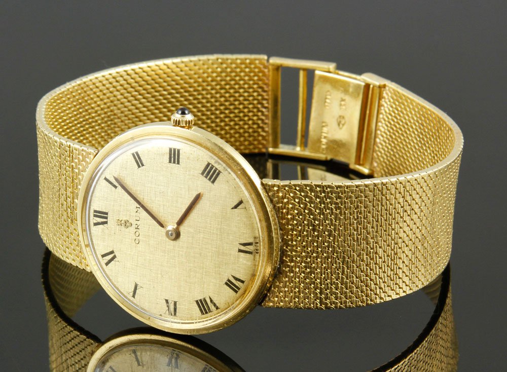 18K Gold Corum Classique Watch: Mens 18K gold Corum Classique wrist watch, 33mm manual wind, 50.9 penny weights inclduing works.