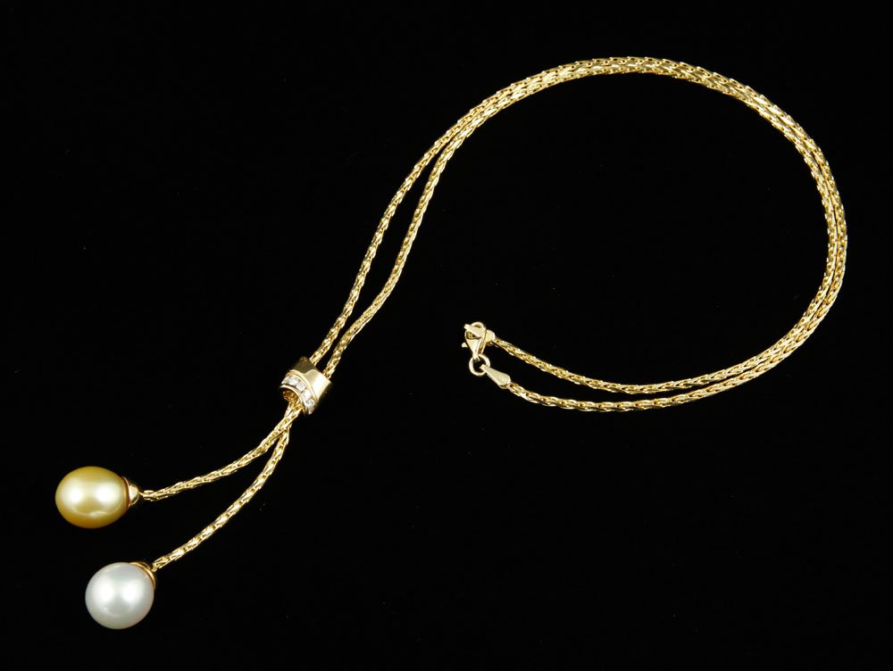 14K Diamond and Pearl Necklace: 14K yellow gold, diamond, and pearl necklace, set with seven round brilliant diamonds, two pearl drops, one white lustrous, and one lustrous golden, each approximately 11 mm, by Nahokv, approximately