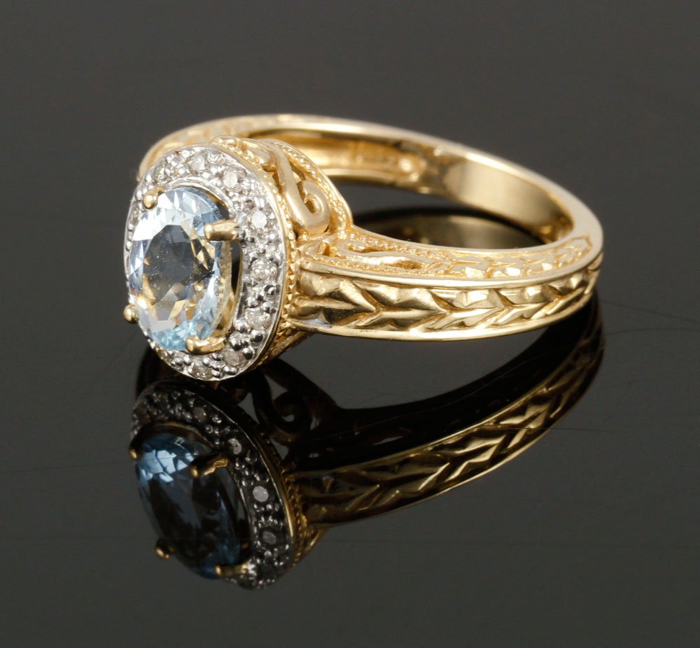 14K Diamond and Aquamarine Ring: 14K yellow gold, diamond, and aquarmarine ring, aquamarine approximately 6 x 8 mm, approximately 5 g. TW, size 7 1/4. Provenance: From a Massachusetts estate.