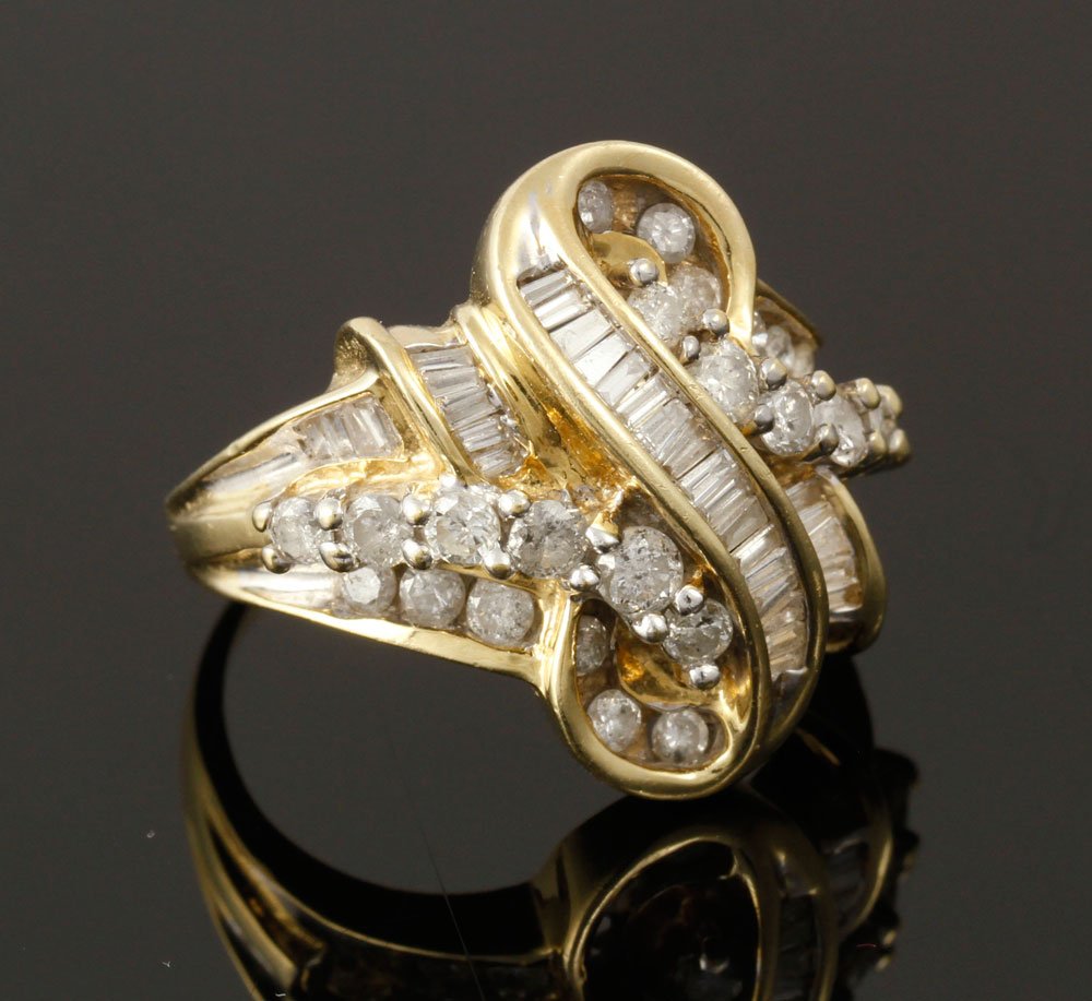 14K Diamond Ring: 14K yellow gold and diamond ring, numerous round brilliants and baguettes, approximately 6 g. TW, size 7 1/4. Provenance: From a Massachusetts estate.