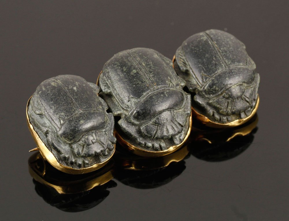 Ancient Egyptian Stone Scarab Pin: Ancient Egyptian stone scarab pin, set in 18K gold, period of Thutmose III, 1 3/4" l. Provenance: From the Estate of Mary L. Alchian Palm Springs, CA.