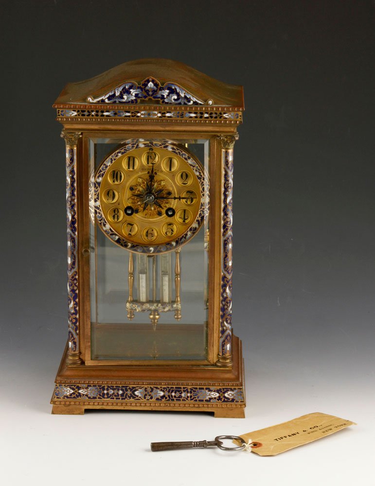 Tiffany & Co. Mantel Clock: Tiffany & Co. mantel clock with gilt face, inlaid decoration on brass case,mercury pendulum, key with original Tiffany tag, 12 1/4" h x 7" w x 5" d. Provenance: From a Massachusetts estate.