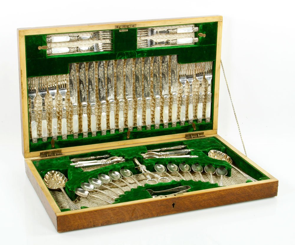 Flatware Dinner Service, Silver Plate: Flatware dinner service, silver plate with mother of pearl handles, in tiger oak case. Provenance: From the Estate of Mary L. Alchian, Palm Springs, CA.
