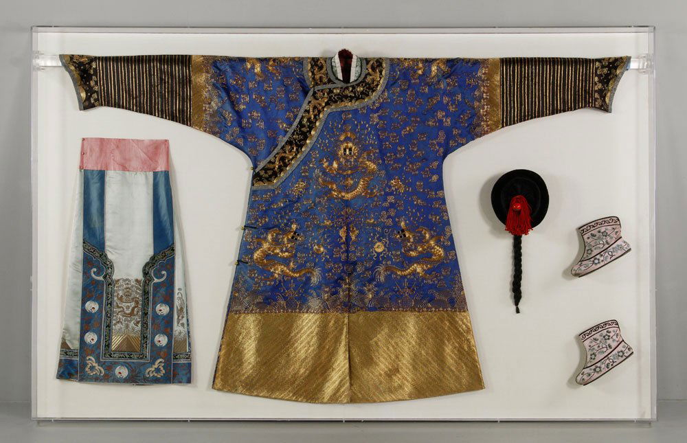 Chinese Robe and Accessories: Robe and accessories, including hat with Peking glass, boots, and skirt, China, silk and other materials, robe embroidered with gold dragons on blue ground, mounted and framed in Plexiglas case, robe