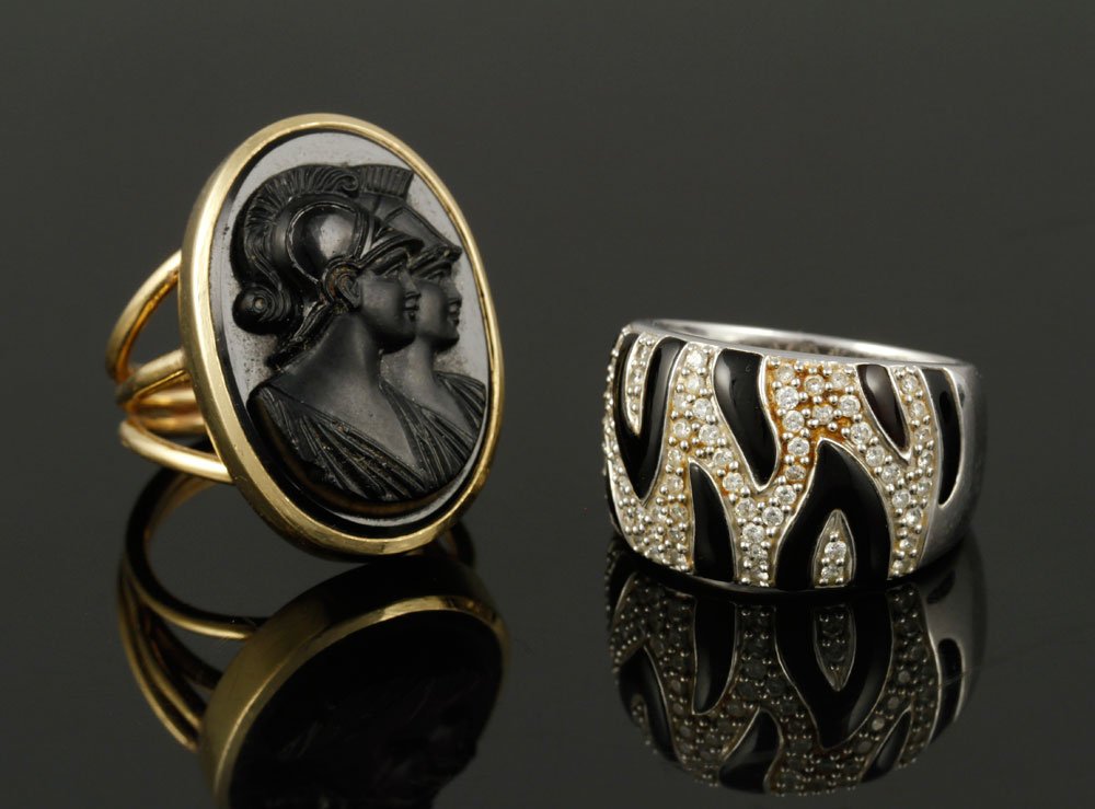 2 14K Gold Rings: Lot of two 14K gold rings, to include: white gold, diamond, a and black enamel, size 7 1/4; yellow gold and intaglio carved onyx, size 7, approximately 22 grams TW. Provenance: MA estate.