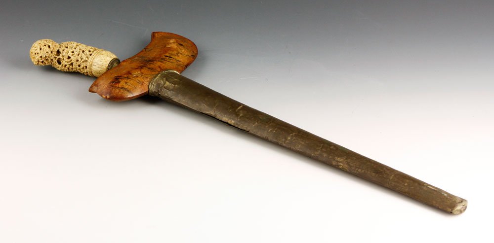 19th C. Middle Eastern Dagger: 19th century Middle Eastern dagger, with intricately carved bone handle, blade is 12 1/2"l, 16 1/4"l overall, 18 1/2"l including sheath. Provenance: From a Charlestown, MA estate.