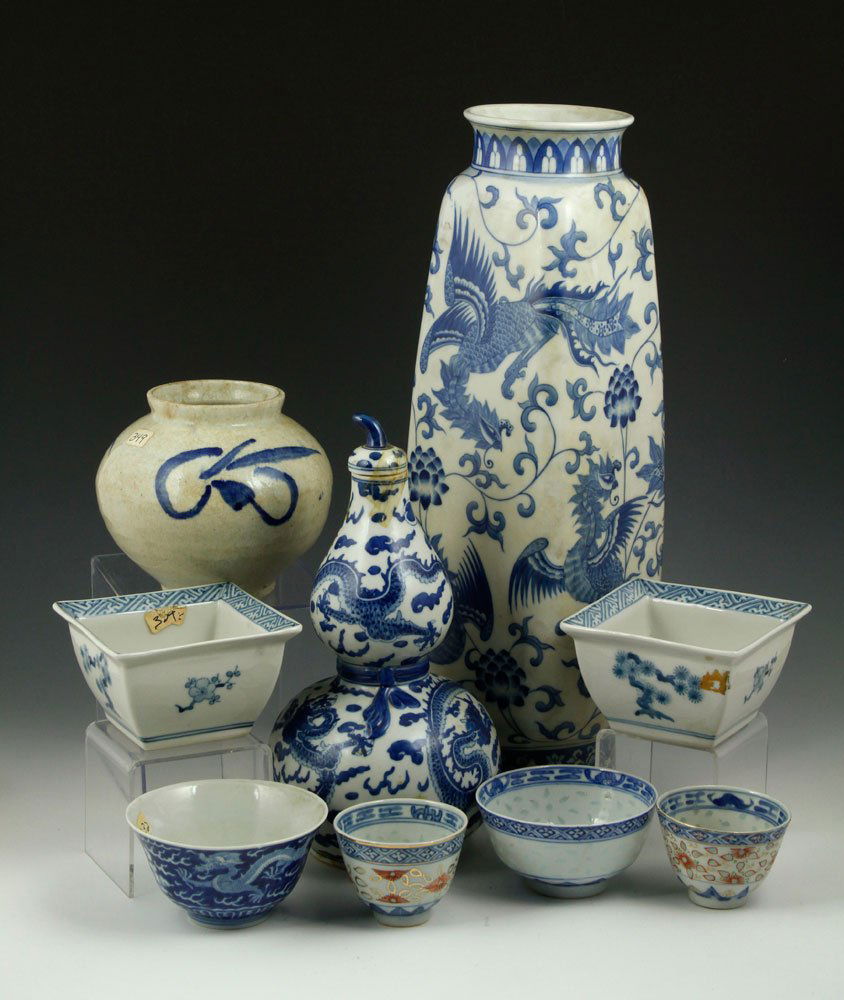 9 Chinese Blue and White Porcelain Items: Lot of nine Chinese blue and white porcelain items, to include: two vases, one double gourd vase with lid, four small cups, and two small planters, tallest 16 1/2" h. Provenance: From the Estate of th