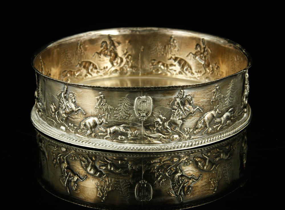 English Sterling Silver Wine Coaster: English wine coaster, sterling silver, decorated with repeated boar hunt scene, 1 1/2" h x 6" w. Provenance: From a Massachusetts estate.