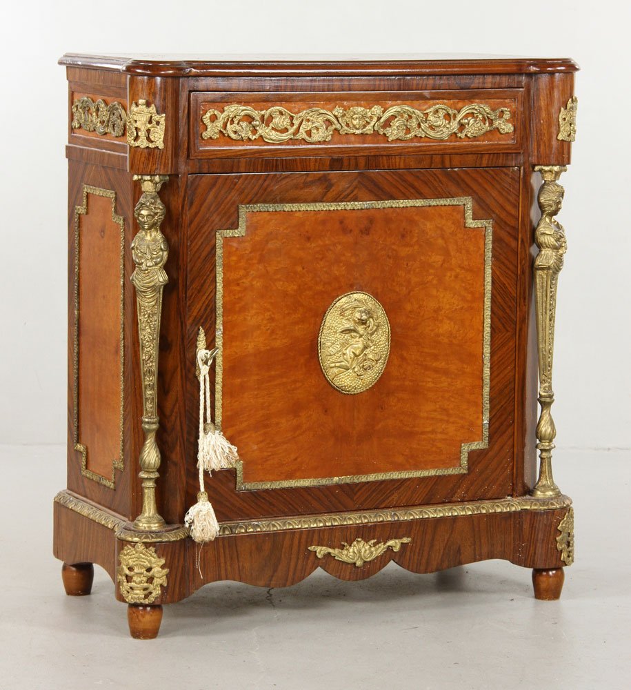 Continental Cabinet with Ormolu: Continental cabinet with extensive ormolu trim, cherub plaque on front door, one drawer, 36" h x 32" w x 16" d. Provenance: From the estate of General Alexander M. Haig Jr., U. S. Secretary of State u