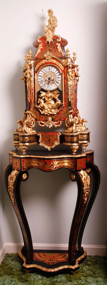 Napoleon III Stye Boulle Clock and Stand: Napoleon III style boulle clock and stand, ebonized wood with gilt metal mounts, clock decorated with a chariot scene, clock 40" h, stand 38" h. Provenance: From the estate of the late Raymond Bolduc 