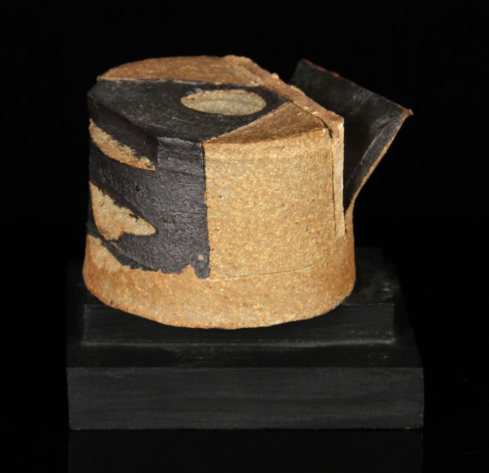 Hadzi, Stoneware Sculpture: Dimitri Hadzi (American, 1921-2006), stoneware sculpture on wooden spindle base, signed "D. Hadzi, NY 03," 2 1/8"h x 3 1/8" dia. Provenance: From a Massachusetts estate.