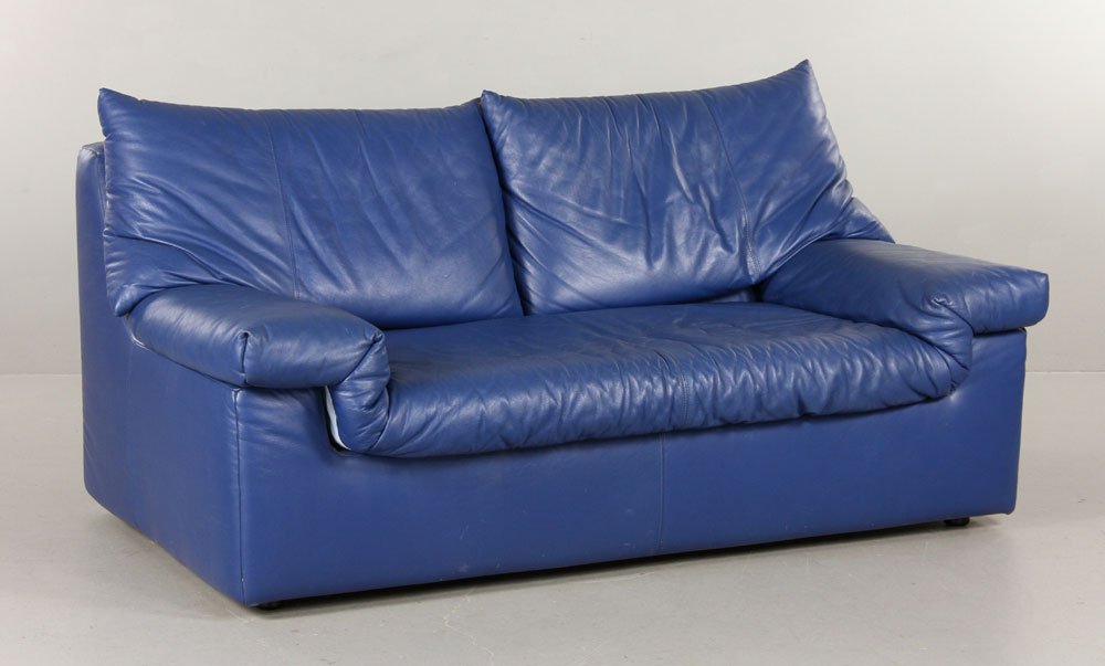 Ligne Roset Love Seat: Ligne Roset love seat, blue leather upholstery, with original label underside, 28"h x 61"w x 36"d. Provenance: From a MA estate.