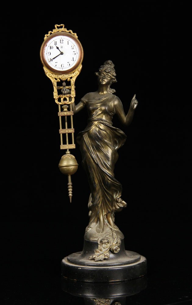 German Bronze Figural Pendulum Clock: German pendulum clock supported by bronze female figure, marked "Junghans Germany" on face, 13" h. Provenance: From a Massachusetts estate.