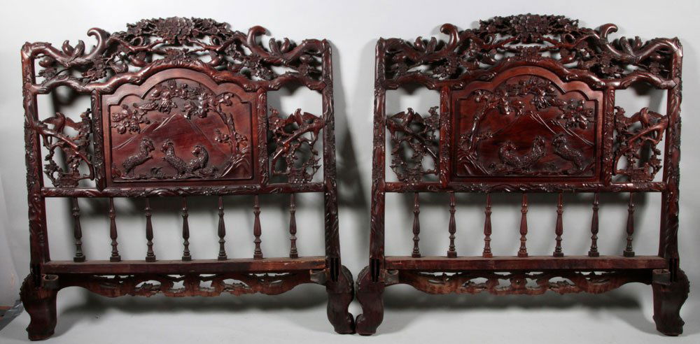 Pr. Chinese Headboards: Pair of Chinese headboards, rosewood, pierced with birds perched on blossoming branches, with central panel carved in relief with goats in a field, reverse incised with plum blossoms, with spindles be