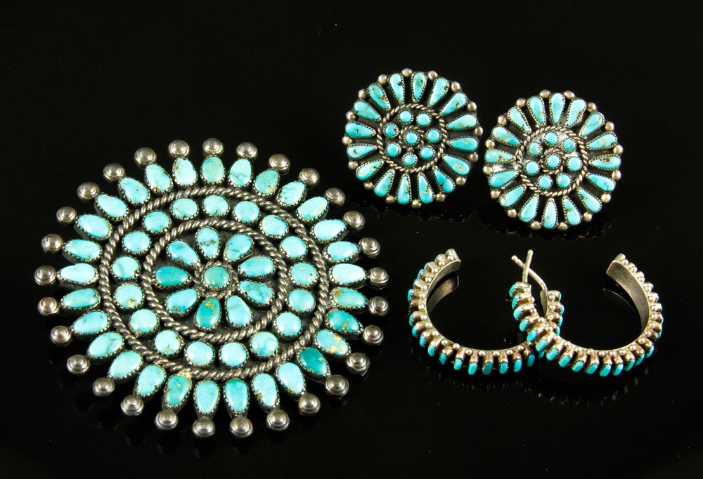 Suite of Zuni Turquoise and Silver Jewelry: Suite of Zuni turquoise and silver jewelry including; 2 1/4"dia sunburst pin having 3 rings of turquoise beads, matching pair of screw-back earrings and a pair of silver and turquoise loop earrings.