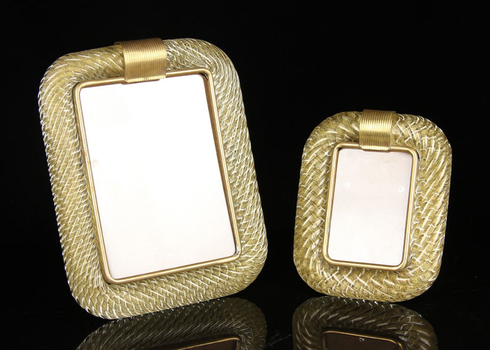 2 Italian Murano Glass Picture Frames: Lot of two Italian Murano glass picture frames, clear with gold, one 12" h x 9 1/2" w, the other 9" h x 7" w. Provenance: From the unreserved collection of Mrs. Jackie Pearson of San Diego, California