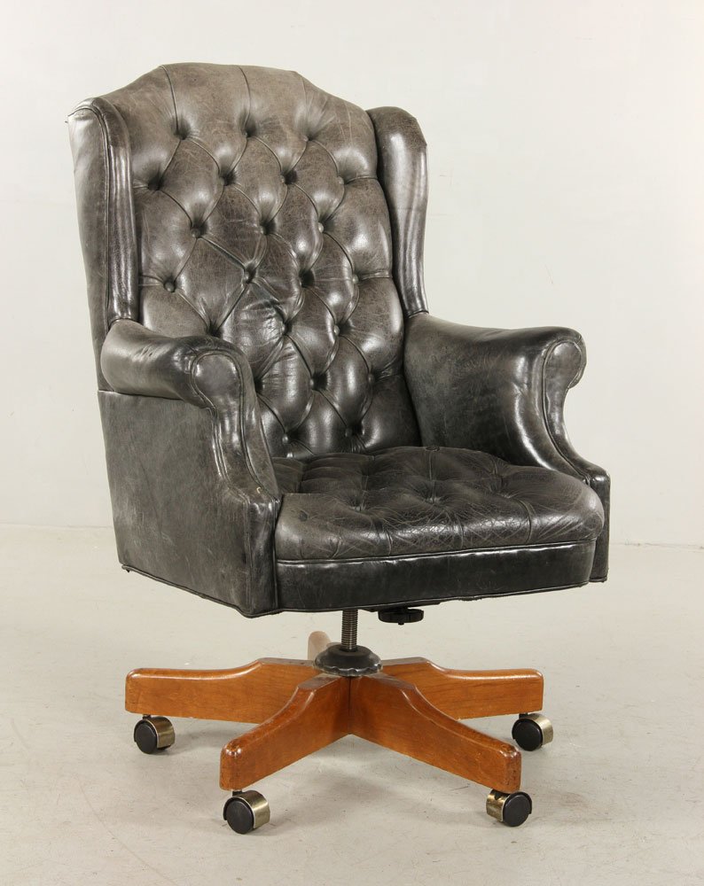 Edwardian Style Wing Chair: Edwardian Style wing back easy chair, upholstered in a button tufted gray leather, with rollover arms and caster mounted. Provenance: From the unreserved estate of a prominent Los Angeles attorney.