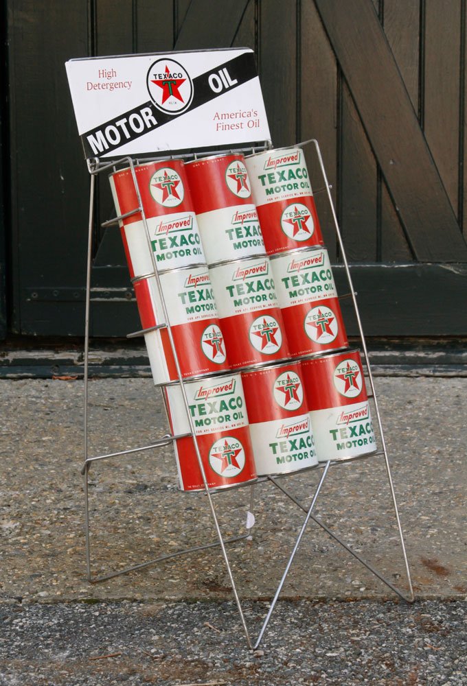 Texaco Motor Oil Display: Texaco motor oil display with nine oil cans, 28 1/2"h x 12"w x 13"d. Provenance: From the Massachusetts estate of Robert Leslie, retired Lexington policeman.